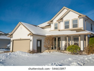 Family Luxury House With Front Yard In Snow. Residential House On Winter Sunny Day