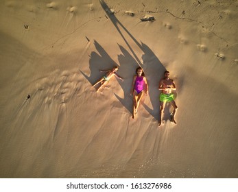 Family Lying Down On Beach Aerial Top View Drone Shot At Seychelles, Mahe