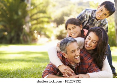 Family Lying On Grass In Countryside - Shutterstock ID 181239332