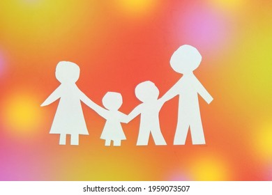 family made of paper, a symbol of a happy strong family, against the glare. children's Day, family day