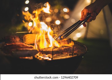 Family making barbecue in dinner party camping at night