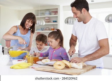 Family Making Breakfast In Kitchen Together