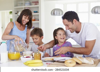 Family Making Breakfast In Kitchen Together