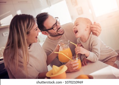 Family Making Juice In Their Kitchen.People,love,family,food And Drink Concept.