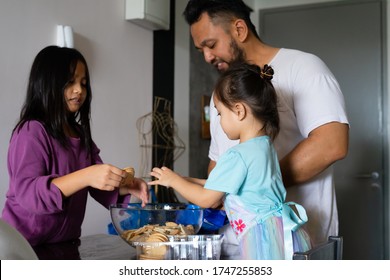 Family Making Kek Batik Or Malaysian Triple Chocolate Dessert. Doing The Initial Steps, Crushing The Cookies Into Tiny Pieces.