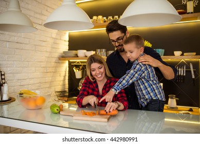 Family Making Lunch Together In The Kitchen.