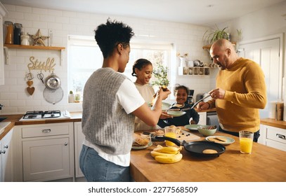 Family making pancakes for breakfast - Powered by Shutterstock