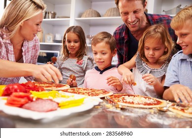 Family Making Pizza For Dinner