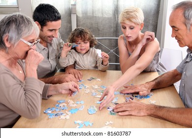 A Family Making A Puzzle