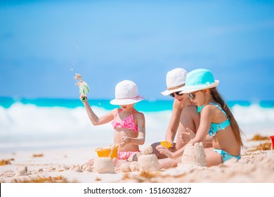 Family Making Sand Castle At Tropical White Beach