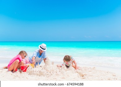 Family Making Sand Castle At Tropical White Beach