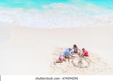 Family Making Sand Castle At Tropical White Beach