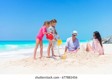 Family Making Sand Castle At Tropical White Beach