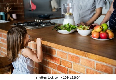 Family Making Smoothie In The Kitchen