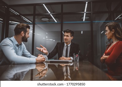 Family Mediation. A Lawyer Mediating A Dispute Between Wife And Husband