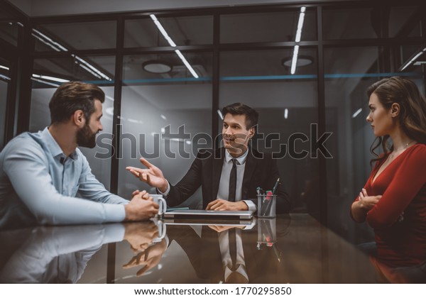 Family mediation. A lawyer mediating a dispute\
between wife and husband