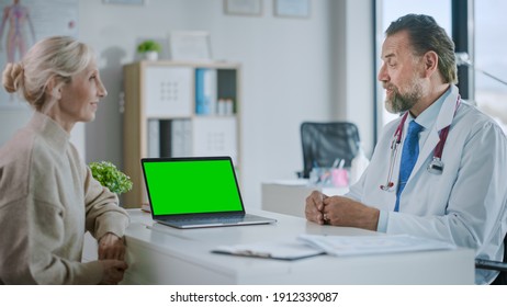 Family Medical Doctor is Explaining Diagnosis to a Senior Patient on a Computer with Green Screen in a Health Clinic. Assistant in White Lab Coat is Reading Medical History in Hospital Office. - Powered by Shutterstock