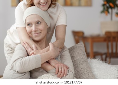 Family member supporting sick woman during chemotherapy treatment