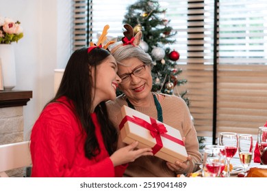 Family members are exchanging gifts with each other in the dinner time during the Christmas holiday at home - Powered by Shutterstock