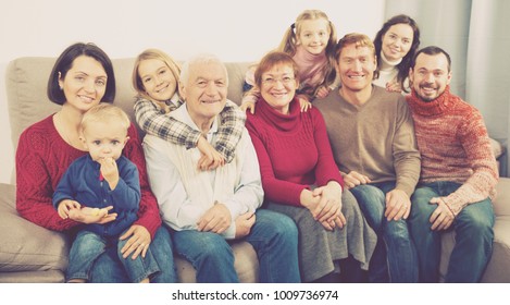 Family Members Making Family Photo During Reunion Party On Sofa