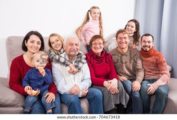 Family members making the family photo during the\
reunion party 