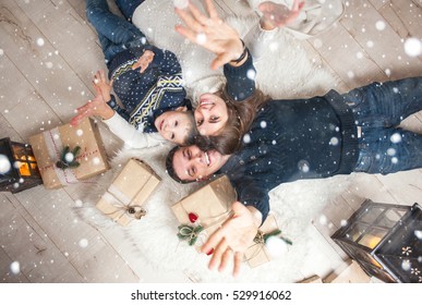 Family, Mom, Dad, Son And Are Looking Up, Laughing, And Pleased, To Catch The Snow On Christmas Eve/Family Portrait