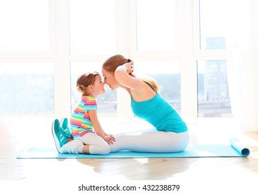 family mother and child daughter are engaged in fitness, yoga, exercise at home