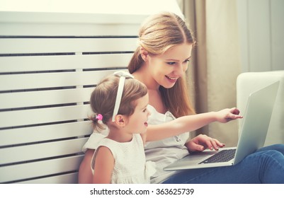 Family Mother And Child Daughter At Home With A Laptop