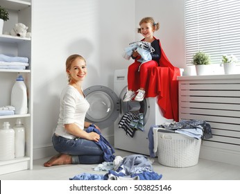 Family Mother And Child Girl Little Superhero Helper In Laundry Room Near Washing Machine And Dirty Clothes