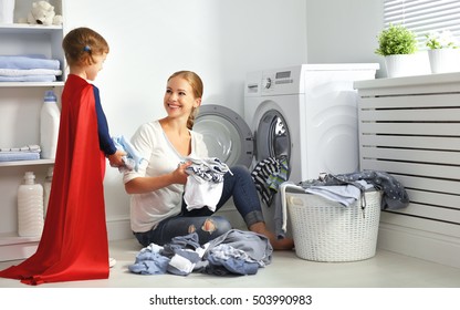 Family Mother And Child Girl Little Superhero Helper In Laundry Room Near Washing Machine And Dirty Clothes