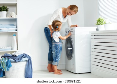 Family Mother And Child Girl Little Helper In Laundry Room Near Washing Machine And Dirty Clothes