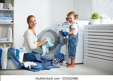 Family Mother And Child Girl Little Helper In Laundry Room Near Washing Machine And Dirty Clothes