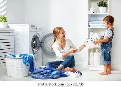 Family Mother And Child Girl Little Helper In Laundry Room Near Washing Machine And Dirty Clothes
