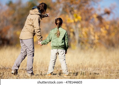 Family Of Mother And Child On African Safari Vacation Enjoying Bush View