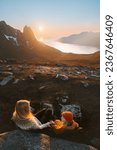 Family mother and child sitting in camping chairs outdoor travel in Norway mountains mom with daughter hiking together adventure vacations lifestyle enjoying sunset landscape