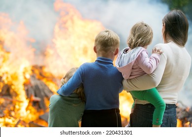 Family Mother With Children At Burning House Fire Accident Background