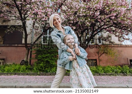 Similar – Granddaughter hugging her grandmother