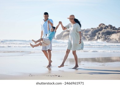 Family, mother and father with a child at the beach for fun, adventure and play on holiday. A happy woman, man and young kid walking on sand or swinging on vacation at the ocean, nature or outdoor - Powered by Shutterstock