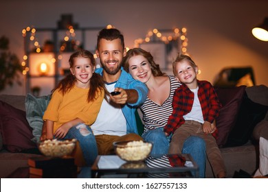 family mother father and children watching projector, TV, movies with popcorn in the evening   at home 
 - Powered by Shutterstock