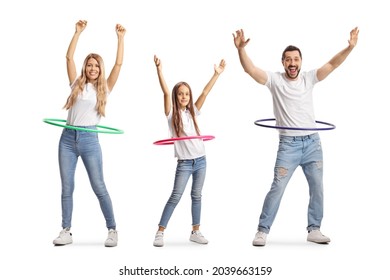 Family of a mother, father and daughter spinning hula hoops isolated on white background
