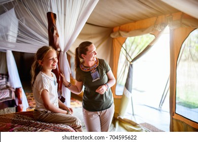 Family Mother And Her Child In Safari Tent Enjoying Vacation In Africa