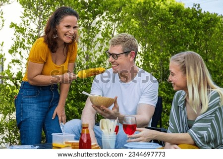 Similar – Gruppe von Freunden, die bei einem Sommergrill kochen.