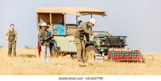 Family Of Mother And Kids On African Safari Vacation Enjoying Bush Breakfast