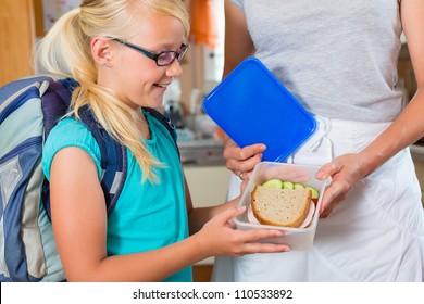 Family - Mother Making Breakfast For Her Children In The Morning And A Snack For School