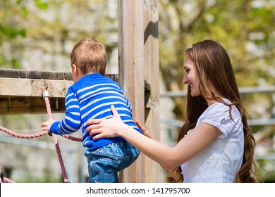 Family - Mother And Son Playing On A Jungle Gym