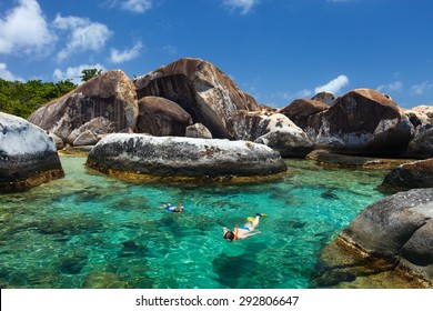 Family Of Mother And Son Snorkeling In Turquoise Tropical Water Among Huge Granite Boulders At The Baths Beach Area Major Tourist Attraction On Virgin Gorda, British Virgin Islands, Caribbean