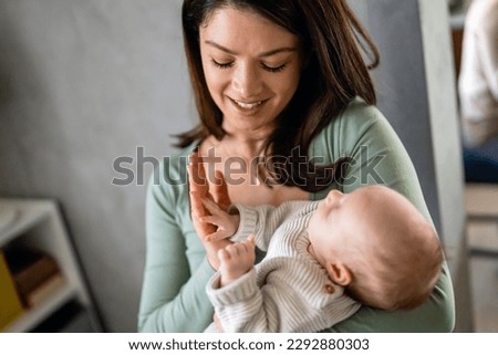 Family, motherhood, parenting, people baby and child care concept. Happy mother with adorable baby