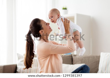 Similar – Image, Stock Photo Mother and baby playing around the Christmas Tree