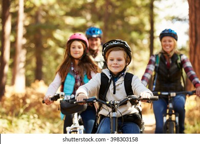 Family Mountain Biking On Forest Trail, Front View, Close-up