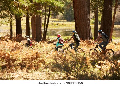 Family Mountain Biking Past Lake, California, USA